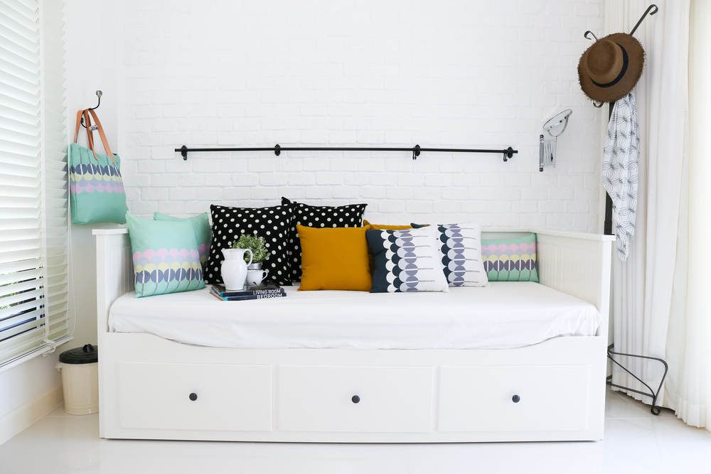 daybed with colourful pillow and white walls